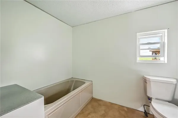 a bathroom with a toilet and a tub