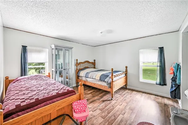 a bedroom with two beds and a large window