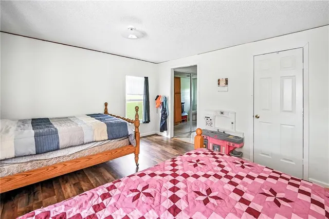 a bedroom with bed and window