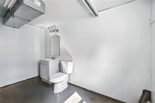 a white toilet sitting next to a bathroom sink