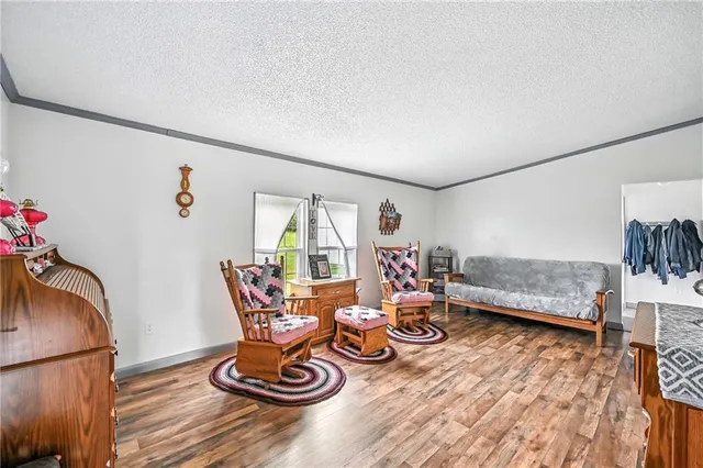 a living room with furniture a window and gym equipment