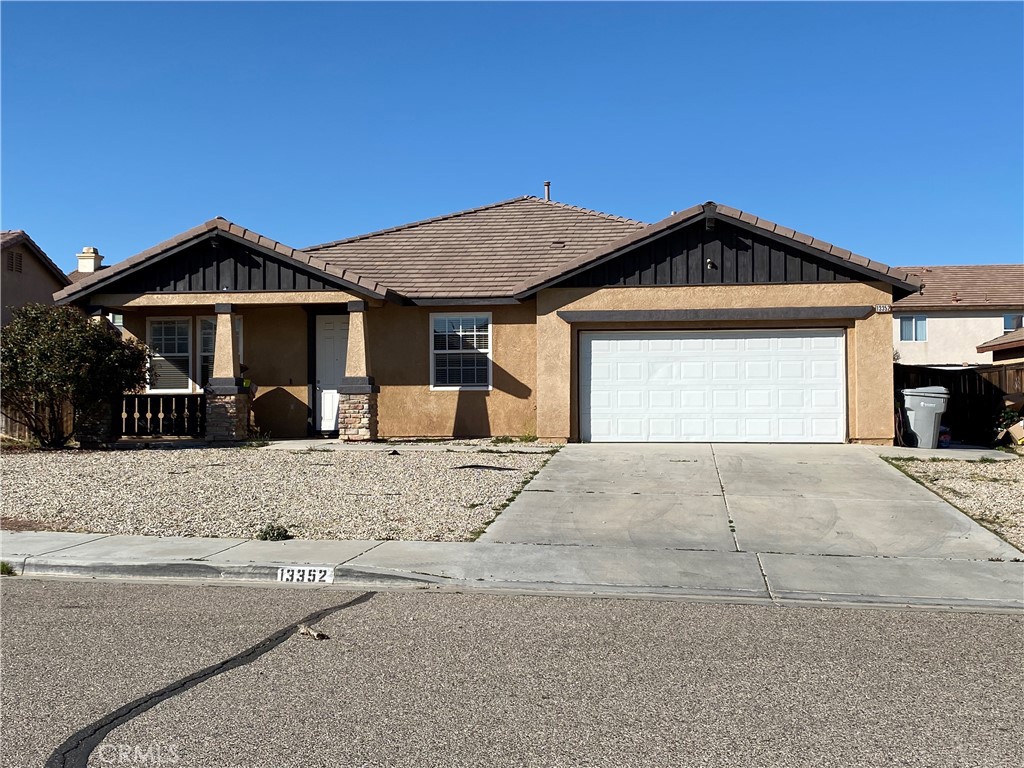 13352 Pleasant View Street Oak Hills, CA 92344 - Photo 1 of 13 a front view of a house with a yard
