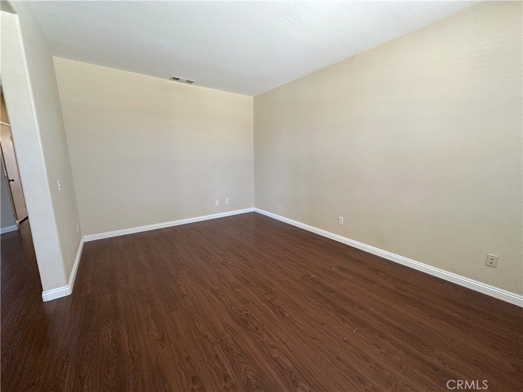 13352 Pleasant View Street Oak Hills, CA 92344 - Photo 12 of 13 an empty room with wooden floor