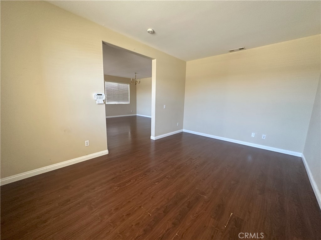 13352 Pleasant View Street Oak Hills, CA 92344 - Photo 3 of 13 a view of a room with wooden floor