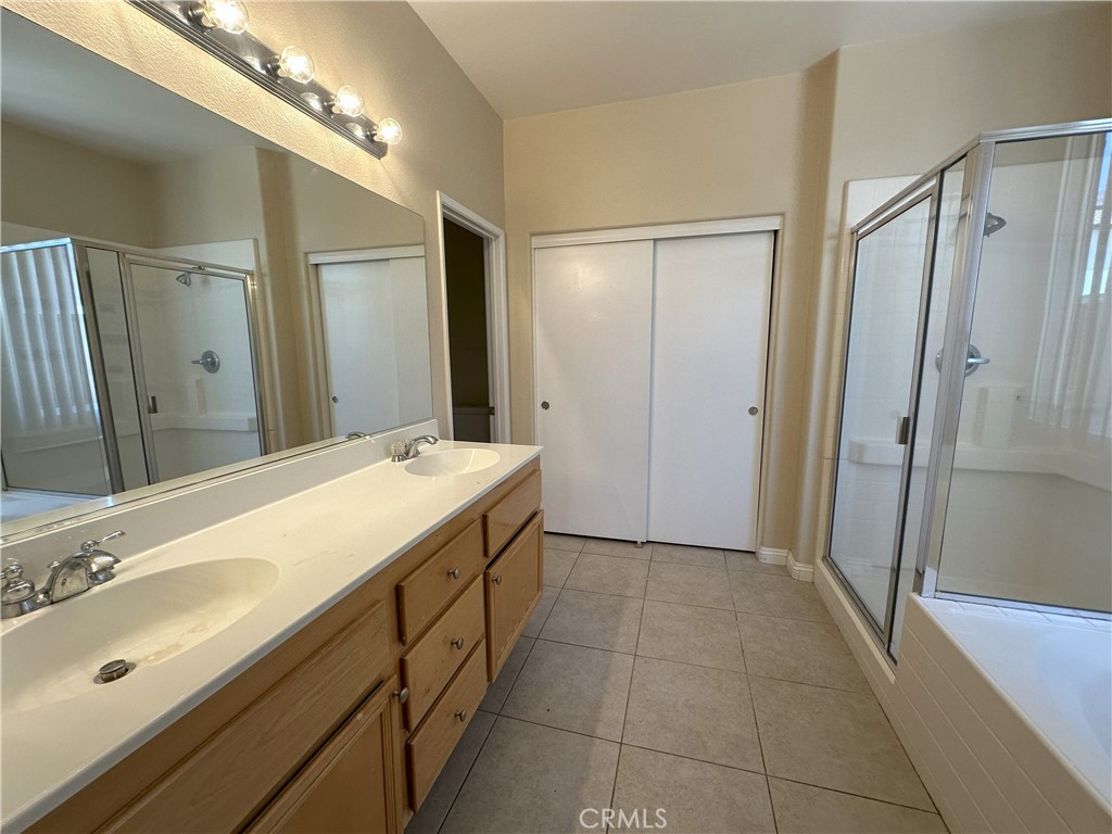 13352 Pleasant View Street Oak Hills, CA 92344 - Photo 9 of 13 a spacious bathroom with a double vanity sink mirror and shower