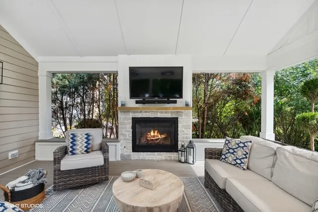 a outdoor space with patio the couches and a fireplace with the garden view
