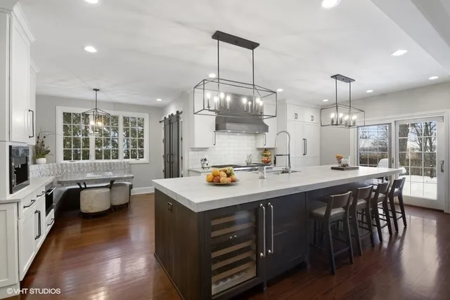 a living room with lots of books and a large window