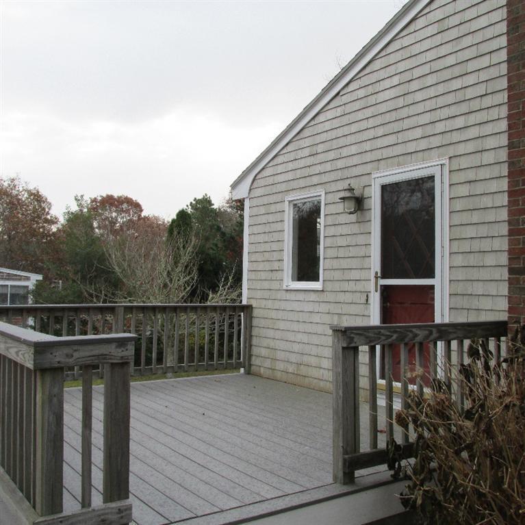 1 Mashnee Road Bourne, MA 02532 - Photo 2 of 29 a view of a roof deck with wooden floor and fence