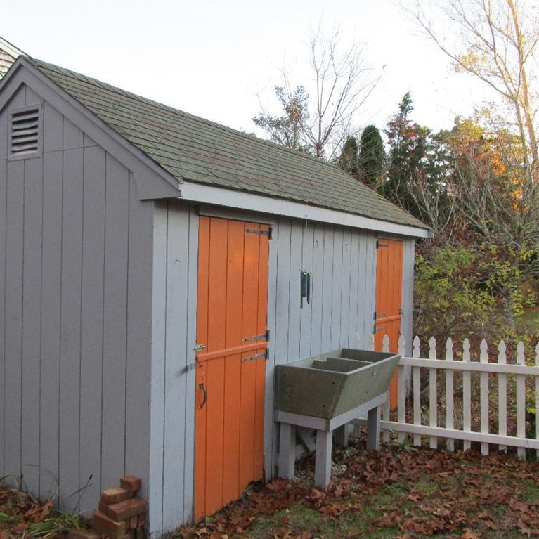 1 Mashnee Road Bourne, MA 02532 - Photo 26 of 29 a backyard of a house with table and chairs