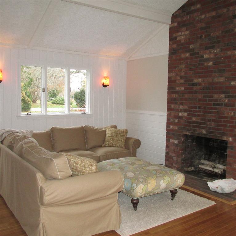 1 Mashnee Road Bourne, MA 02532 - Photo 4 of 29 a living room with furniture and a fireplace