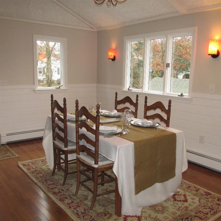1 Mashnee Road Bourne, MA 02532 - Photo 7 of 29 a view of a dining room with furniture and windows