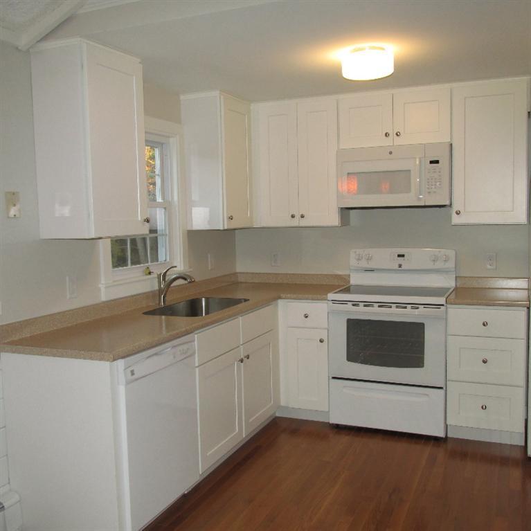 1 Mashnee Road Bourne, MA 02532 - Photo 9 of 29 a kitchen with cabinets appliances a sink and a counter top space