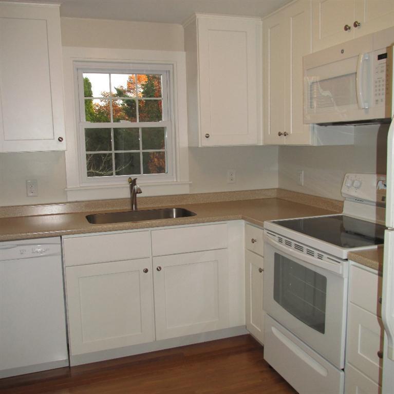 1 Mashnee Road Bourne, MA 02532 - Photo 10 of 29 a kitchen with granite countertop white cabinets and white appliances