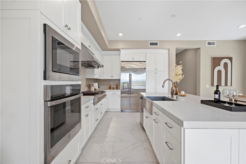 168 Perspective Irvine, CA 92618 - Photo 11 of 62 a kitchen with white cabinets and appliances