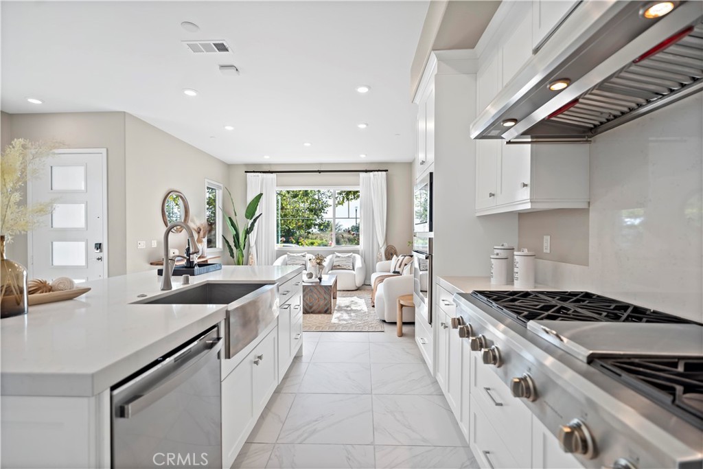 168 Perspective Irvine, CA 92618 - Photo 12 of 62 a kitchen with stainless steel appliances a sink stove and cabinets