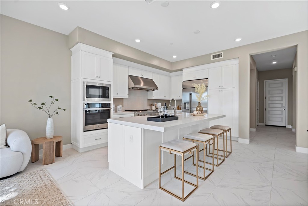 168 Perspective Irvine, CA 92618 - Photo 15 of 62 a kitchen with a sink a stove a refrigerator and white cabinets