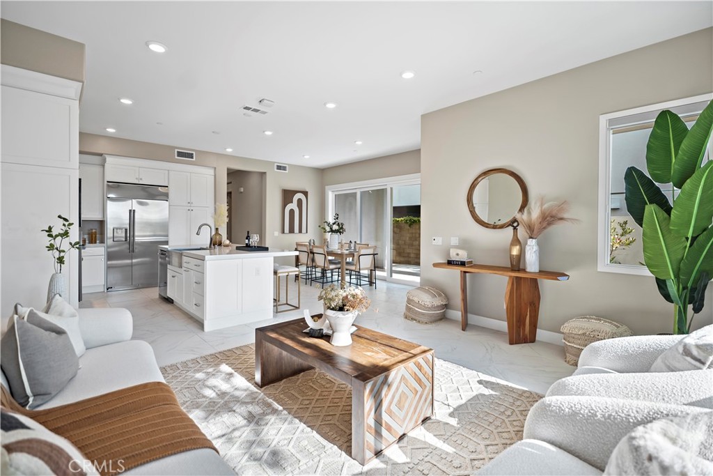 168 Perspective Irvine, CA 92618 - Photo 19 of 62 a living room with furniture a rug kitchen view and a potted plant