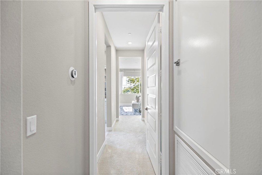 168 Perspective Irvine, CA 92618 - Photo 28 of 62 a view of a hallway with white walls and closet