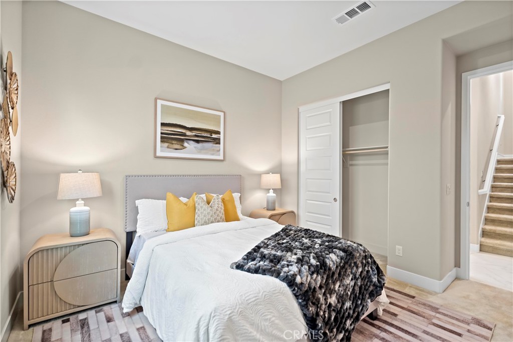 168 Perspective Irvine, CA 92618 - Photo 44 of 62 a bedroom with a bed and wooden floor