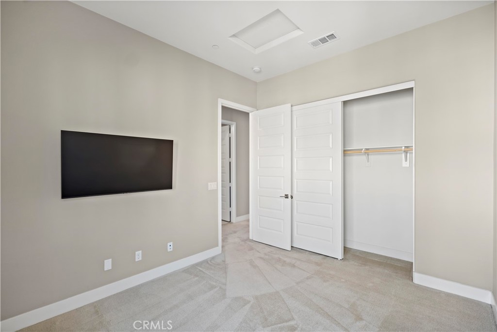168 Perspective Irvine, CA 92618 - Photo 45 of 62 a view of an empty room with a flat screen tv