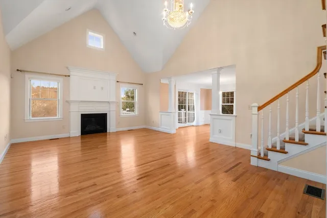 a view of a livingroom with wooden floor and a fireplace