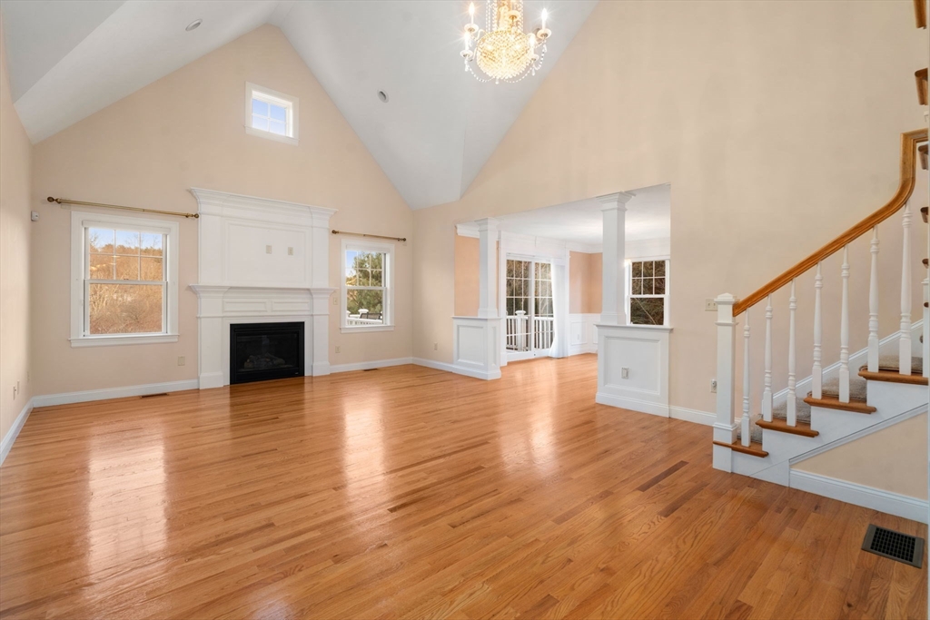 9 River Rock Way, Unit 9 Wayland, MA 01778 - Photo 12 of 39 a view of a livingroom with wooden floor and a fireplace