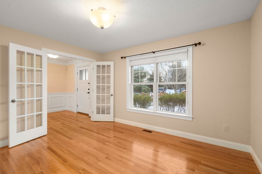 9 River Rock Way, Unit 9 Wayland, MA 01778 - Photo 14 of 39 an empty room with wooden floor and windows