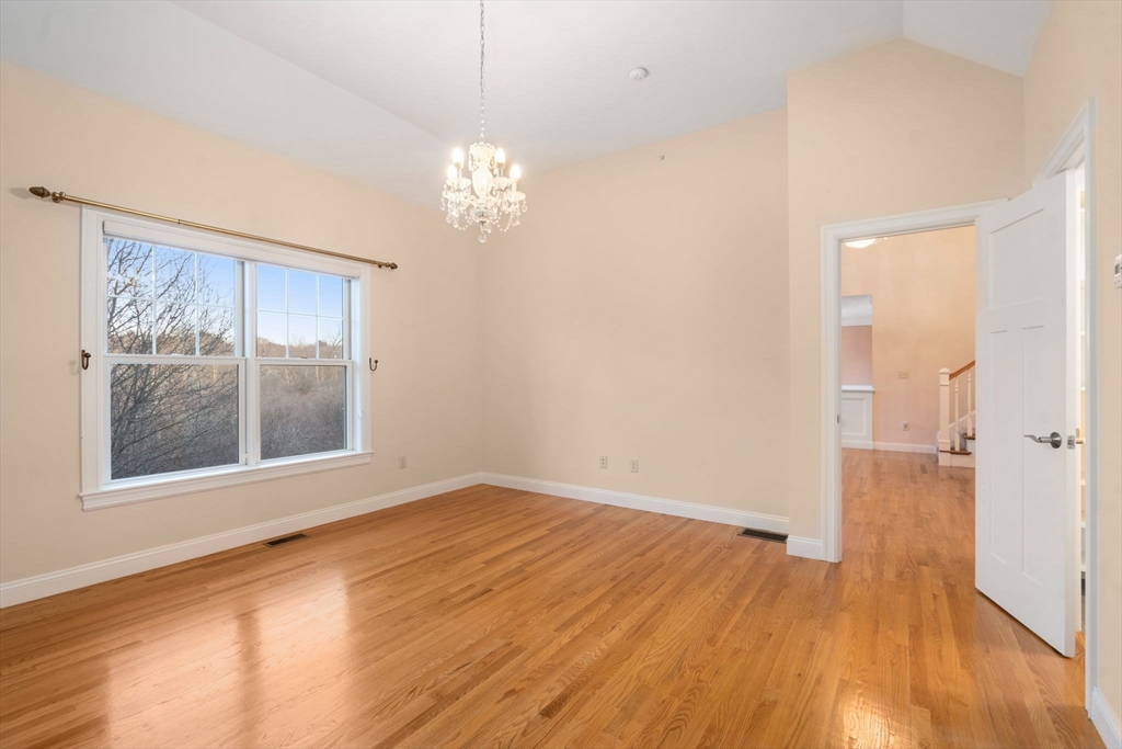 9 River Rock Way, Unit 9 Wayland, MA 01778 - Photo 18 of 39 a view of empty room with wooden floor and fan
