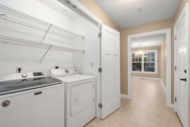a utility room with cabinets washer and dryer