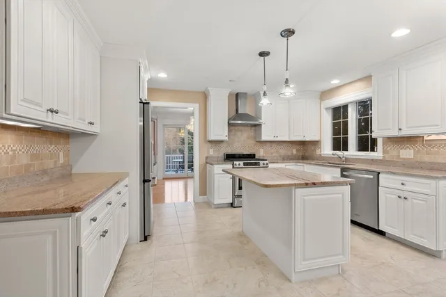 a kitchen with granite countertop white cabinets and white appliances