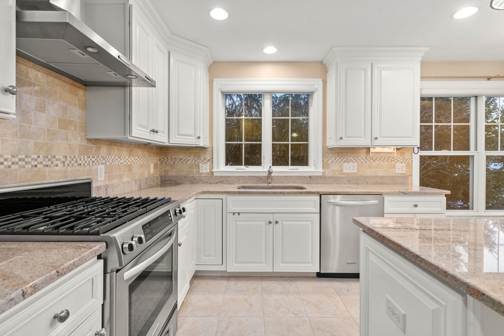 9 River Rock Way, Unit 9 Wayland, MA 01778 - Photo 8 of 39 a kitchen with granite countertop a sink stove and cabinets