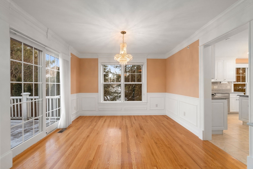 9 River Rock Way, Unit 9 Wayland, MA 01778 - Photo 10 of 39 a view of an empty room with wooden floor and a window