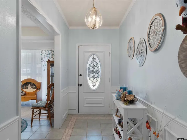 a living room with furniture a fireplace and a large window