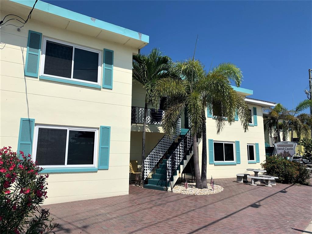 17688 Gulf Boulevard, Unit 102 Redington Shores, FL 33708 - Photo 2 of 14 a front view of a house with a yard
