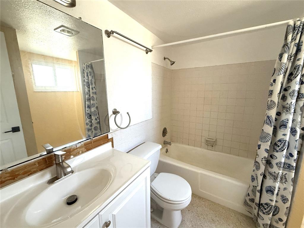 17688 Gulf Boulevard, Unit 102 Redington Shores, FL 33708 - Photo 8 of 14 a bathroom with a sink toilet and shower