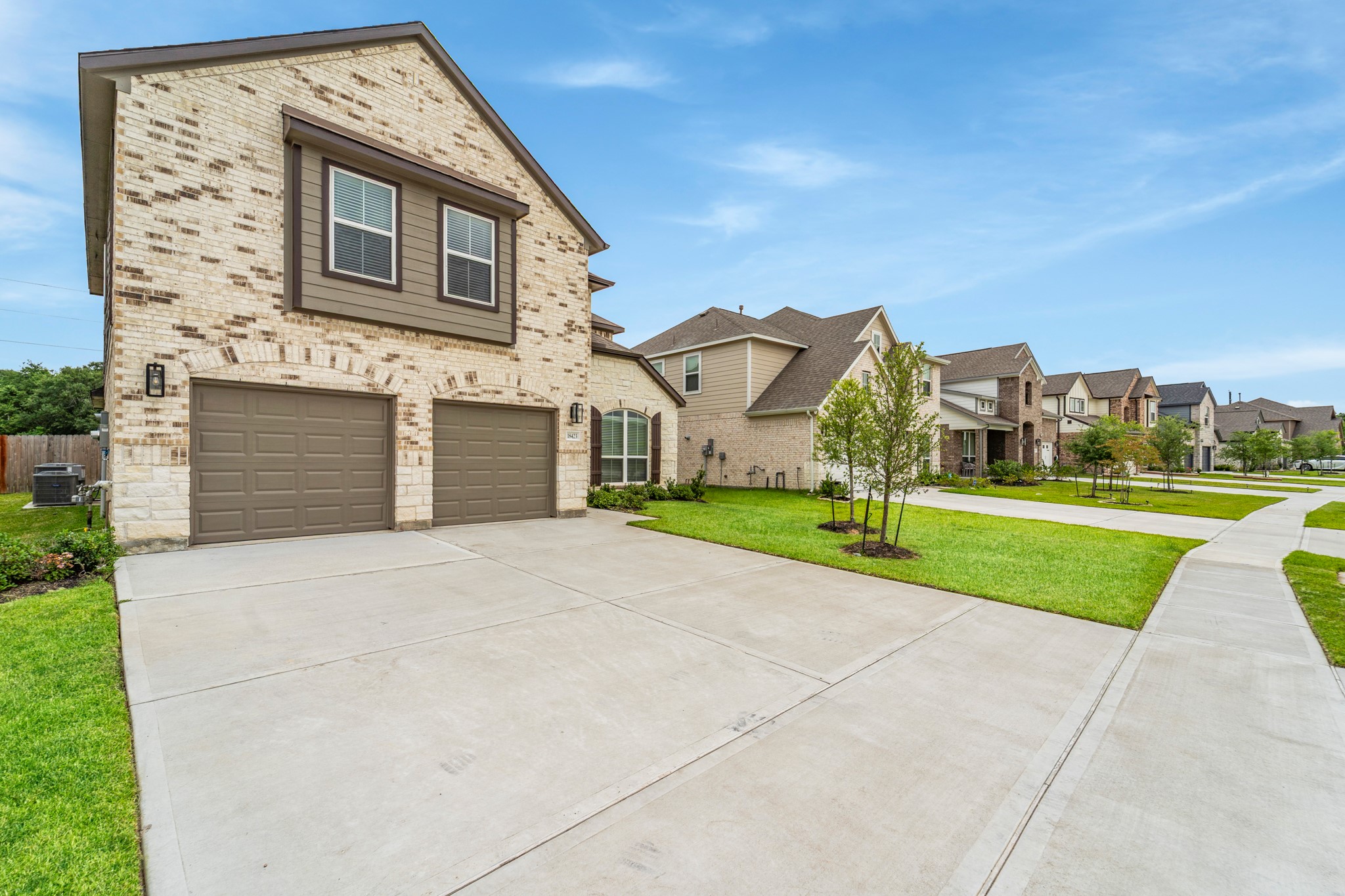 18423 Windy Knl Way Houston, TX 77084 - Photo 2 of 39 a front view of a house with a yard and garage