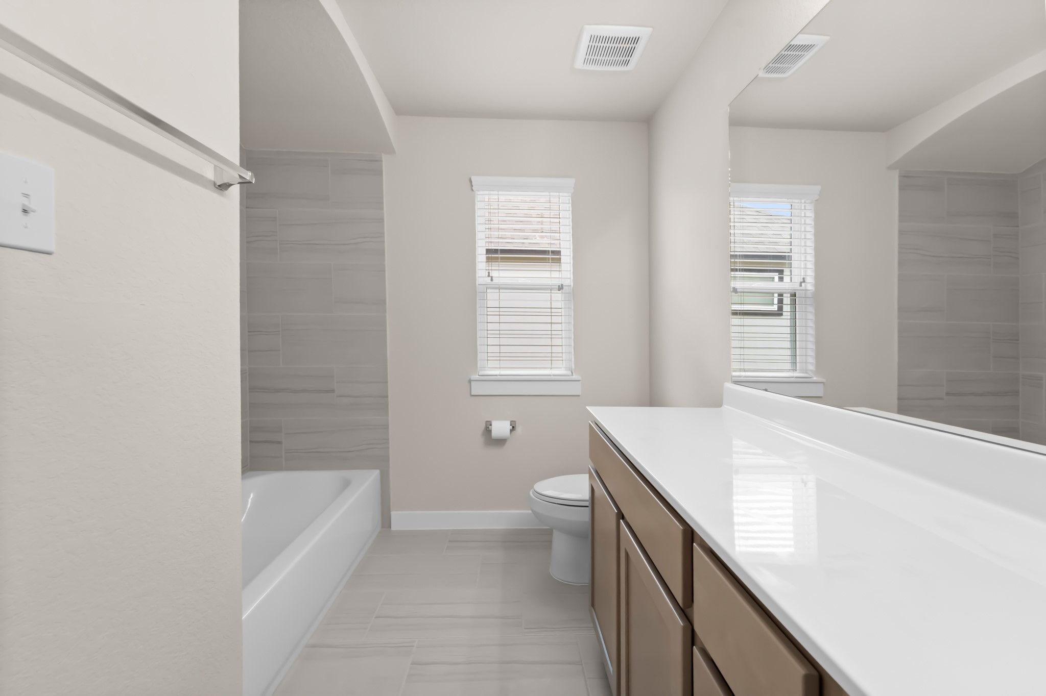 18423 Windy Knl Way Houston, TX 77084 - Photo 34 of 39 a bathroom with a granite countertop sink a toilet and bathtub