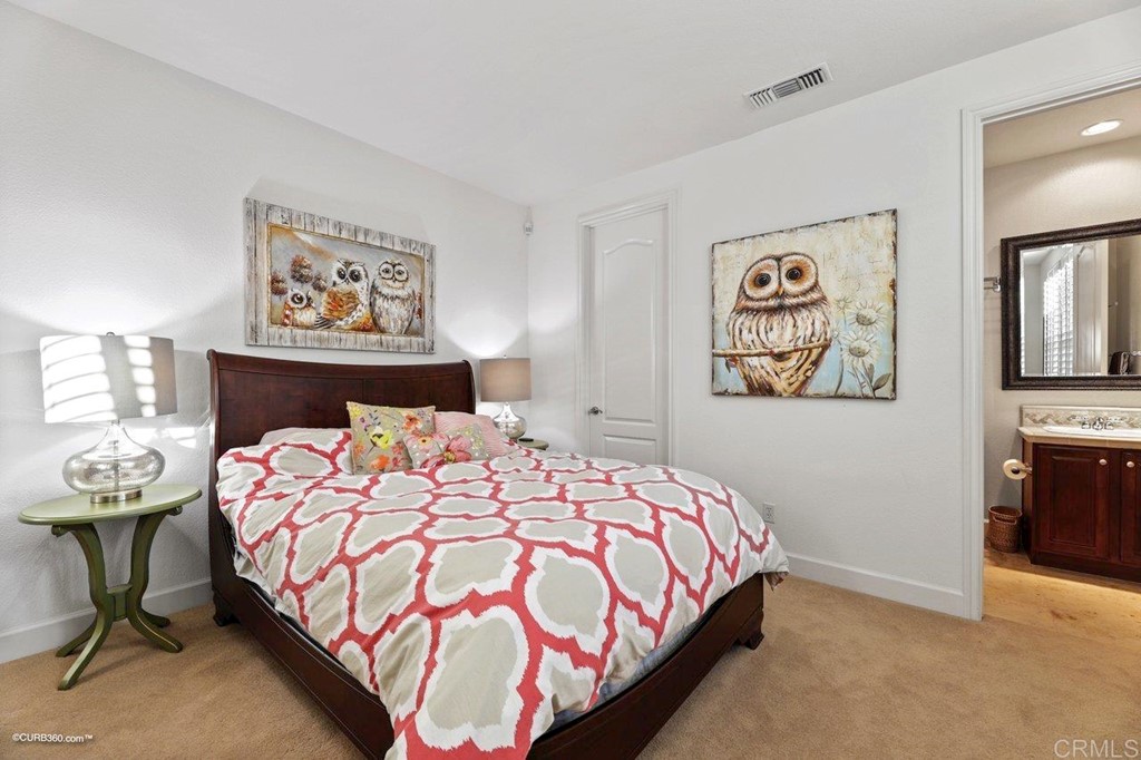 7338 Corte TOMILLO Carlsbad, CA 92009 - Photo 31 of 36 a bedroom with a bed and painting on the wall