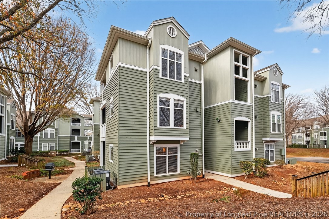 1221 Westview Lane, Unit 301 Raleigh, NC 27605 - Photo 1 of 32 a front view of a house with a yard