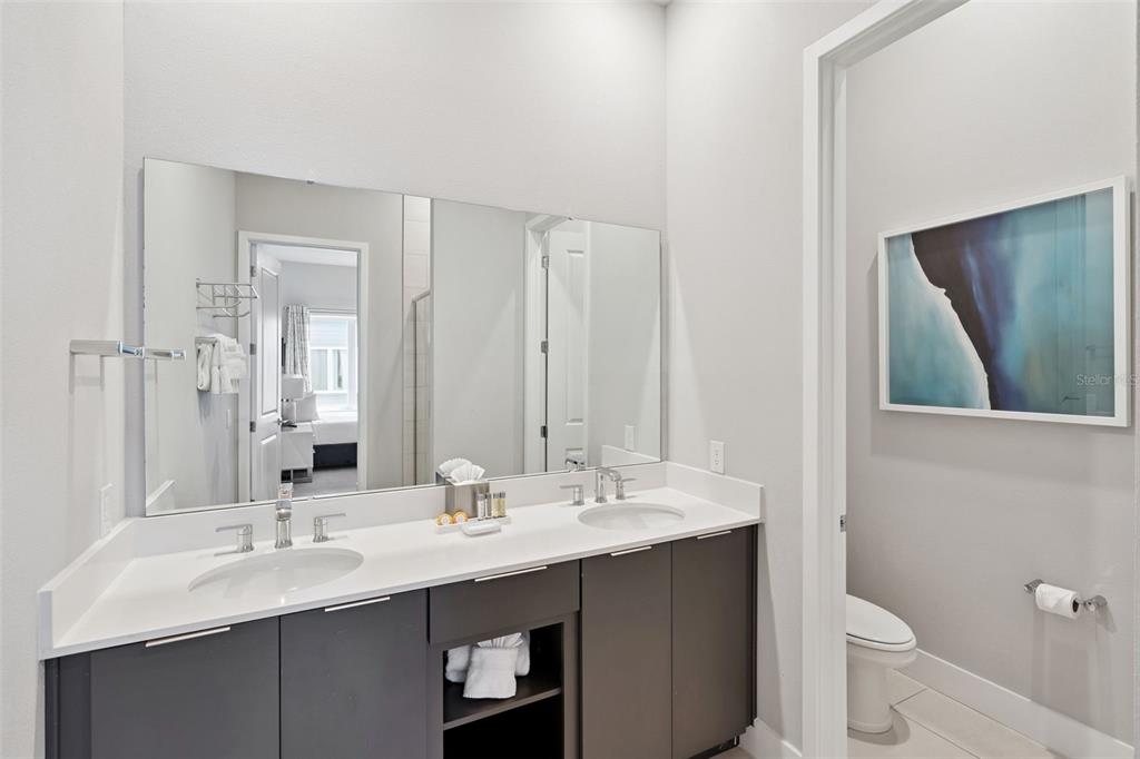 7770 Sandy Ridge Drive, Unit 223 Reunion, FL 34747 - Photo 15 of 51 a bathroom with a double vanity sink and a mirror