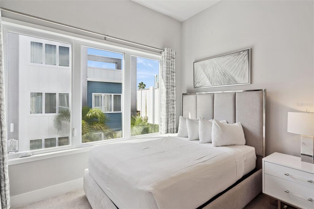 7770 Sandy Ridge Drive, Unit 223 Reunion, FL 34747 - Photo 16 of 51 a bedroom with a large bed and a window