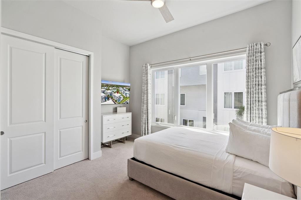 7770 Sandy Ridge Drive, Unit 223 Reunion, FL 34747 - Photo 17 of 51 a bedroom with a bed and a large window