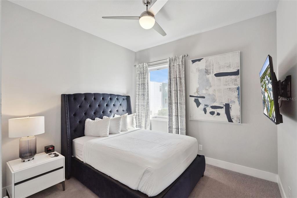 7770 Sandy Ridge Drive, Unit 223 Reunion, FL 34747 - Photo 19 of 51 a bedroom with a bed a couch and a window