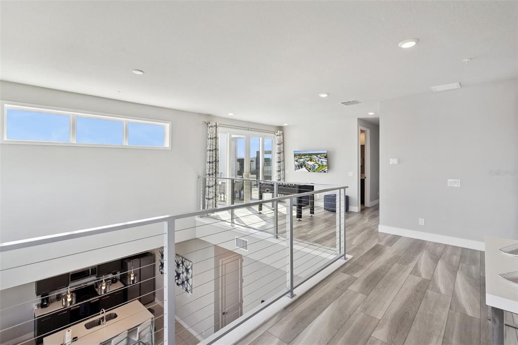 7770 Sandy Ridge Drive, Unit 223 Reunion, FL 34747 - Photo 20 of 51 a view of a kitchen with furniture and wooden floor