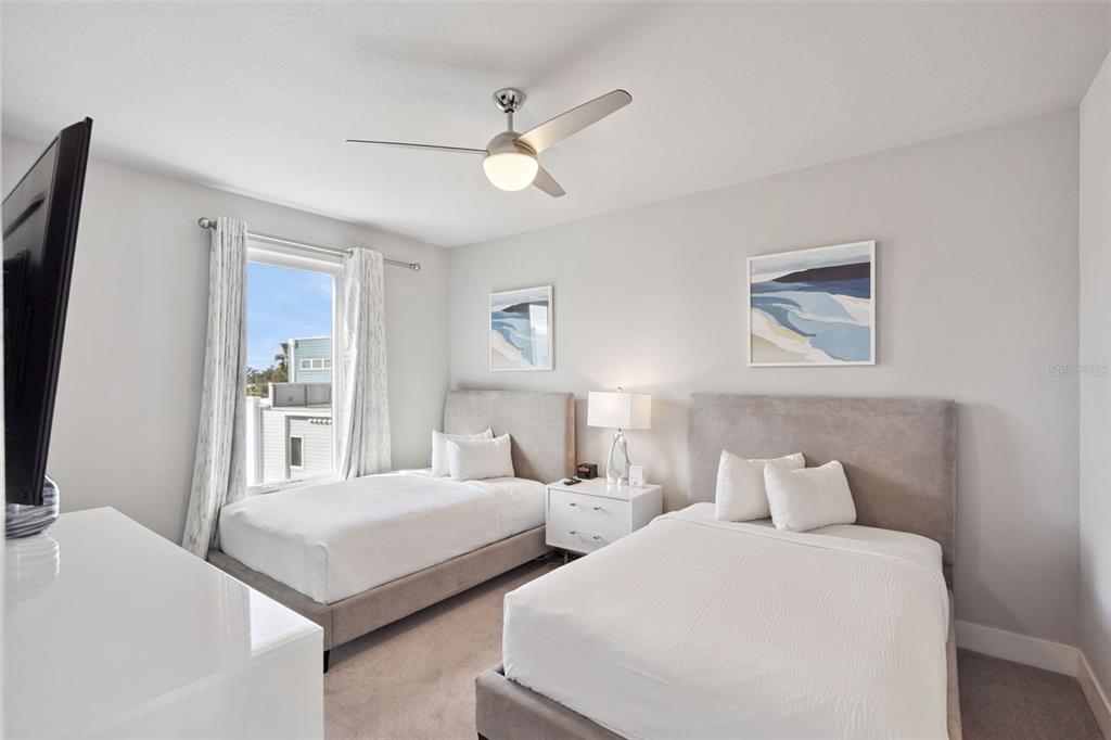 7770 Sandy Ridge Drive, Unit 223 Reunion, FL 34747 - Photo 23 of 51 a bedroom with two beds and painting on the wall