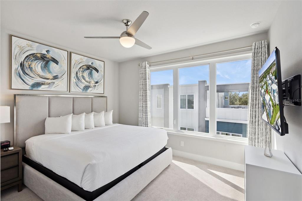 7770 Sandy Ridge Drive, Unit 223 Reunion, FL 34747 - Photo 25 of 51 a bedroom with a large bed and a large window with the outer view