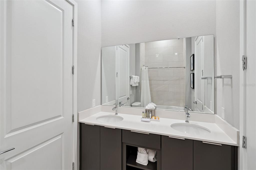 7770 Sandy Ridge Drive, Unit 223 Reunion, FL 34747 - Photo 26 of 51 a bathroom with a sink and a mirror