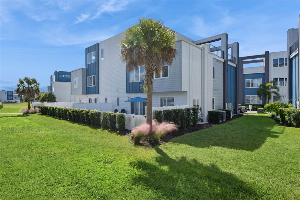 7770 Sandy Ridge Drive, Unit 223 Reunion, FL 34747 - Photo 32 of 51 a view of a house with a backyard and a patio