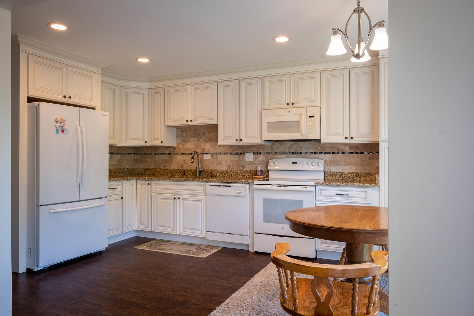 335 Shadow Bend Drive Wheeling, IL 60090 - Photo 3 of 21 a kitchen with stainless steel appliances granite countertop a stove a refrigerator and a white cabinets