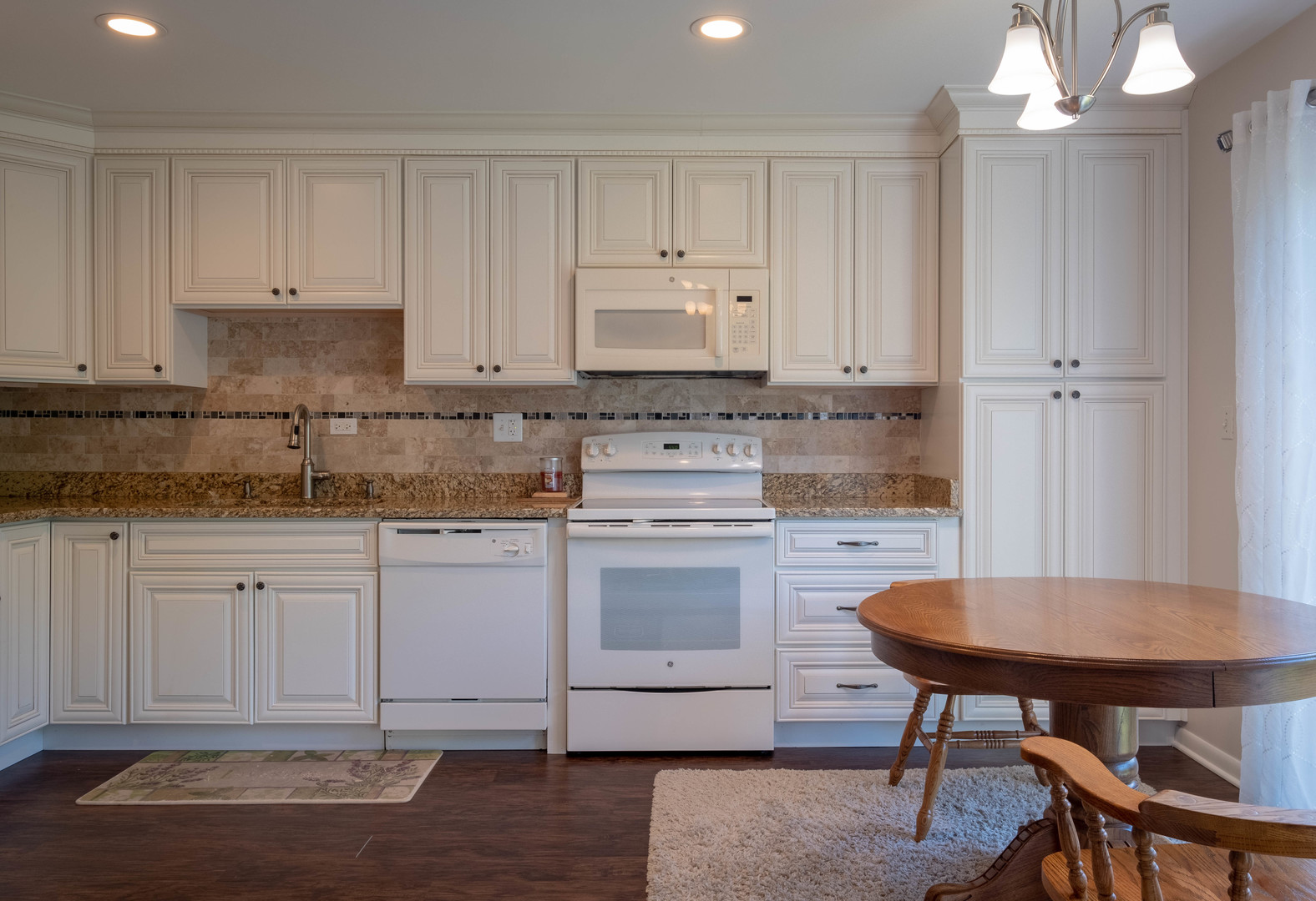 335 Shadow Bend Drive Wheeling, IL 60090 - Photo 4 of 21 a kitchen with a sink cabinets and wooden floor